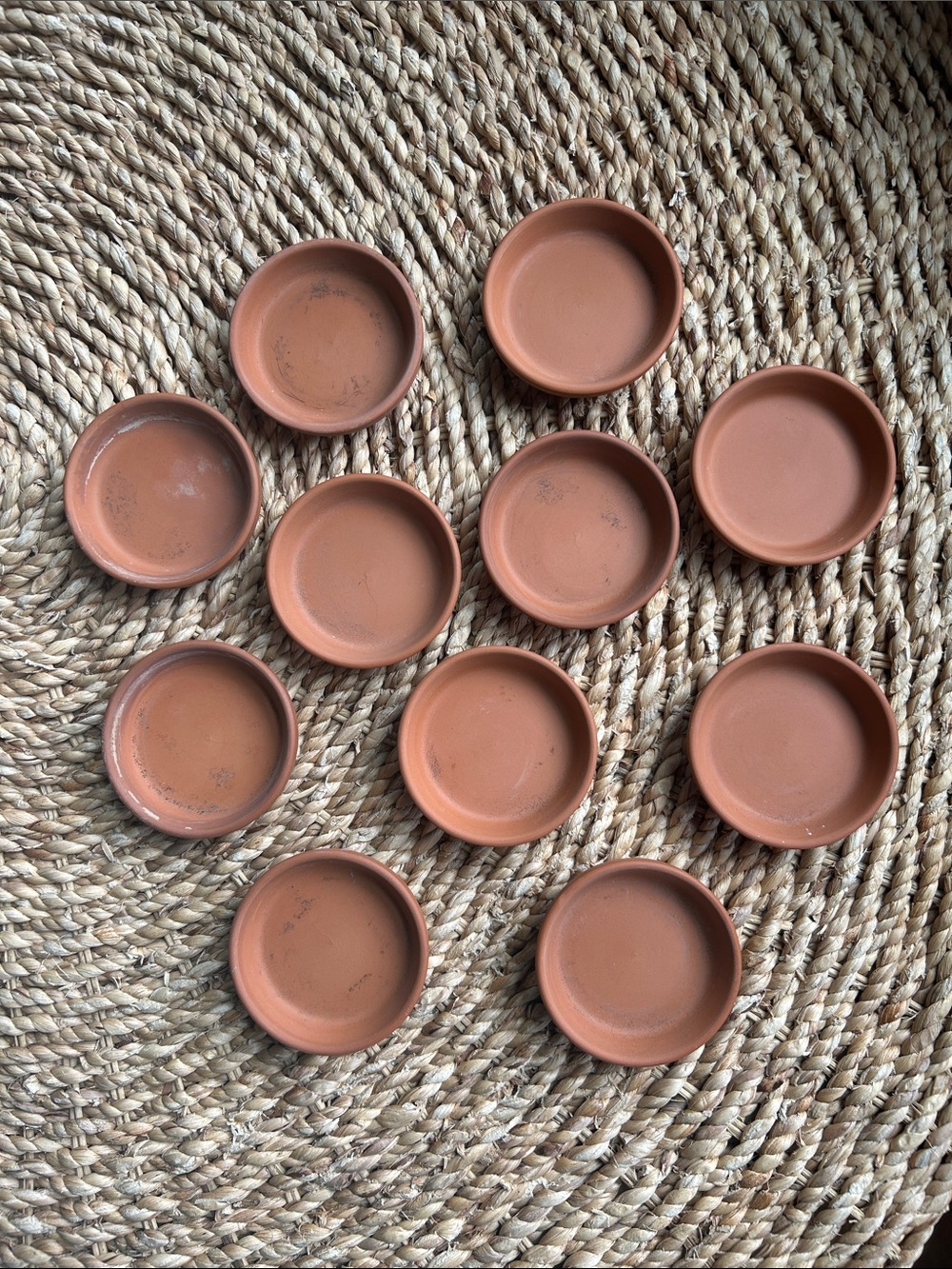 11 Terra Cotta saucers.